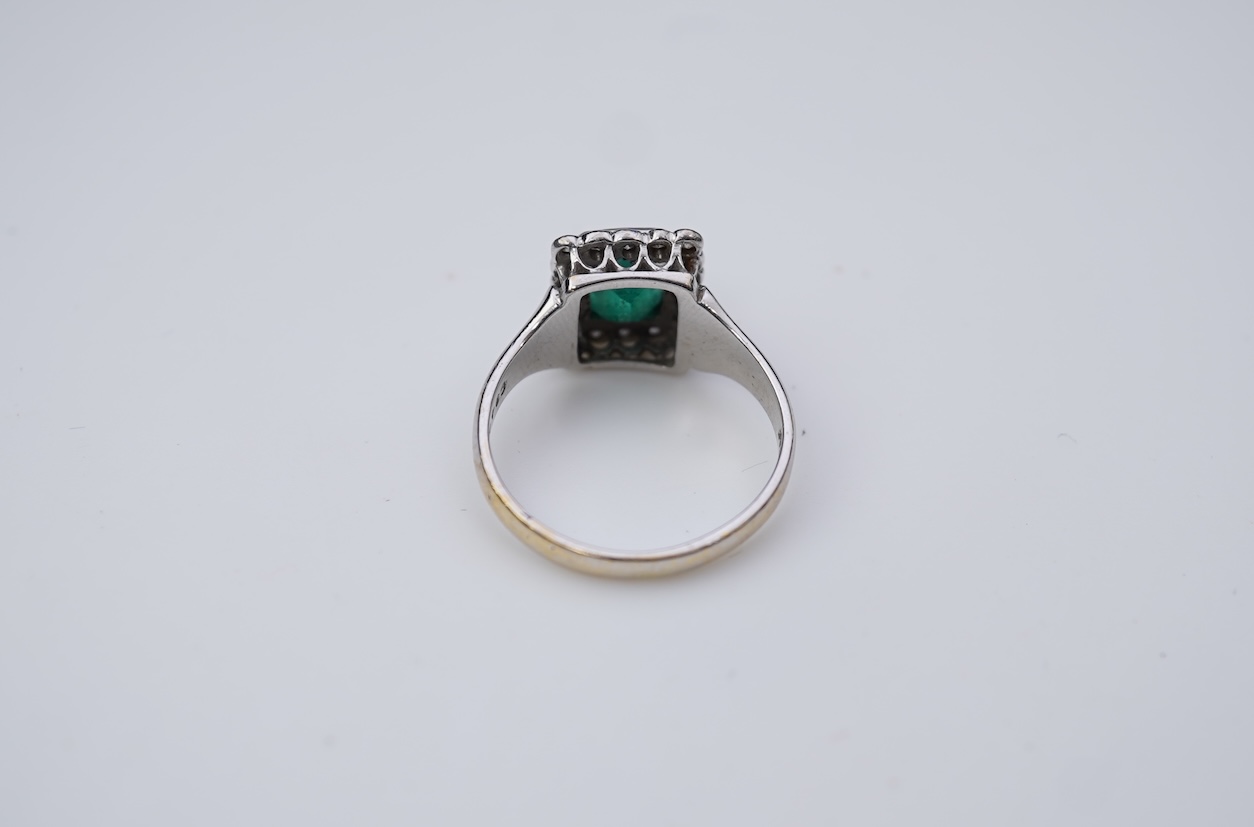 An emerald and diamond ring